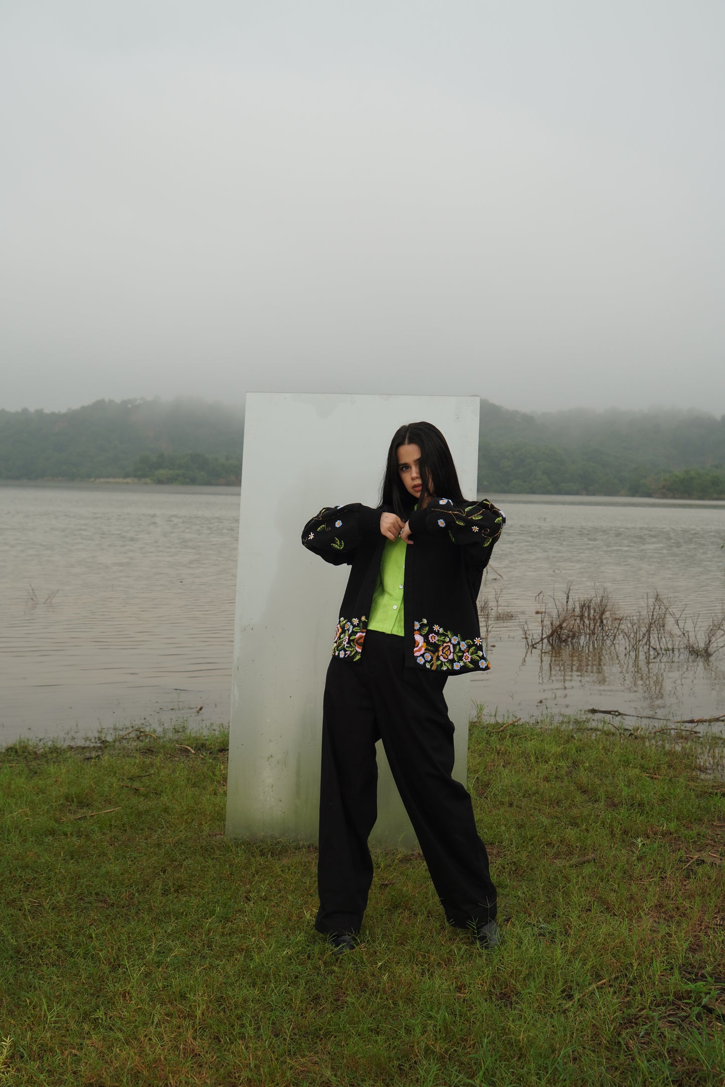 Front view of the beaded Charlie Denim Unisex Jacket Some examples of alt text are “Black
denim jacket (unisex) has beaded embellishments on sleeves” and “Charlie denim jacket in black
with intricate bead detailing.”