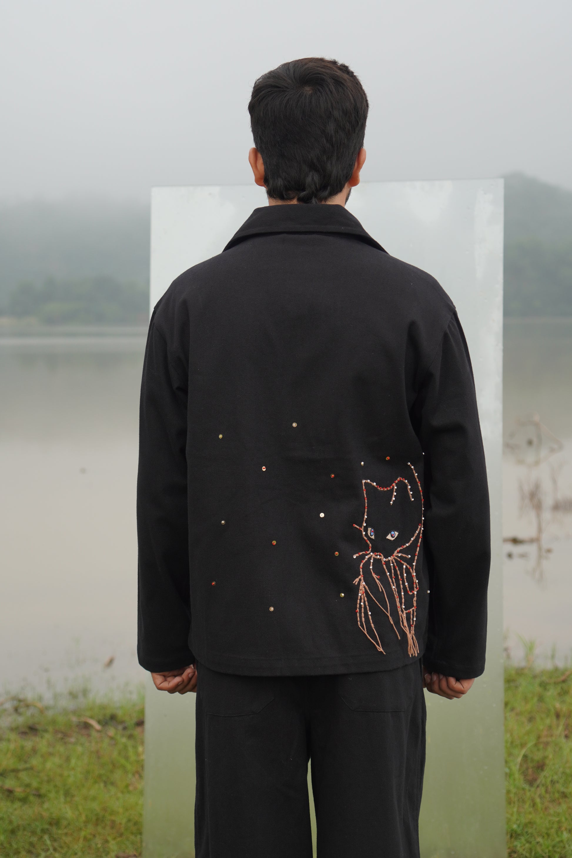 This black Luna unisex denim jacket is embroidered with wool.