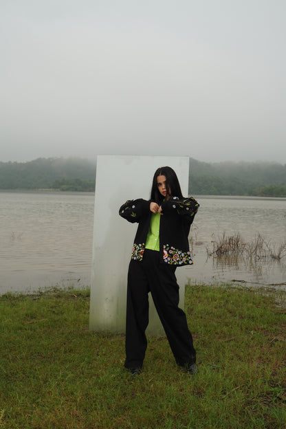 Front view of the beaded Charlie Denim Unisex Jacket Some examples of alt text are “Black 
denim jacket (unisex) has beaded embellishments on sleeves” and “Charlie denim jacket in black 
with intricate bead detailing.”