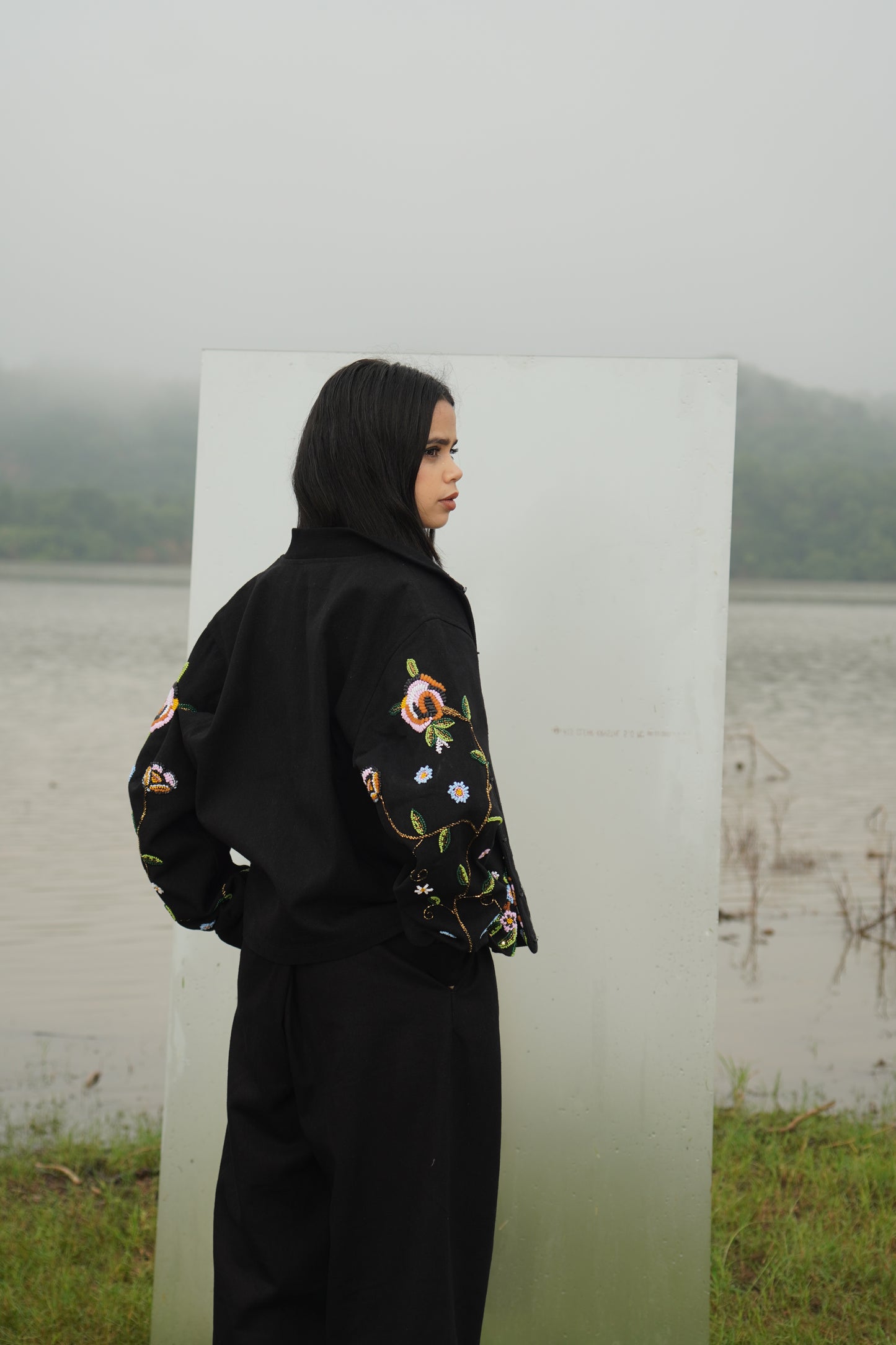 Front view of the beaded Charlie Denim Unisex Jacket Some examples of alt text are “Black 
denim jacket (unisex) has beaded embellishments on sleeves” and “Charlie denim jacket in black 
with intricate bead detailing.”