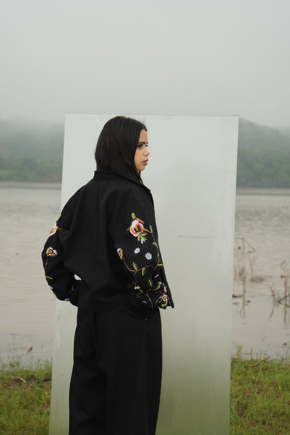 Front view of the beaded Charlie Denim Unisex Jacket Some examples of alt text are “Black 
denim jacket (unisex) has beaded embellishments on sleeves” and “Charlie denim jacket in black 
with intricate bead detailing.”